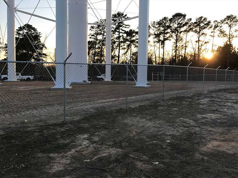 Commercial security chain link fence installation with barbed wire in Lufkin Texas