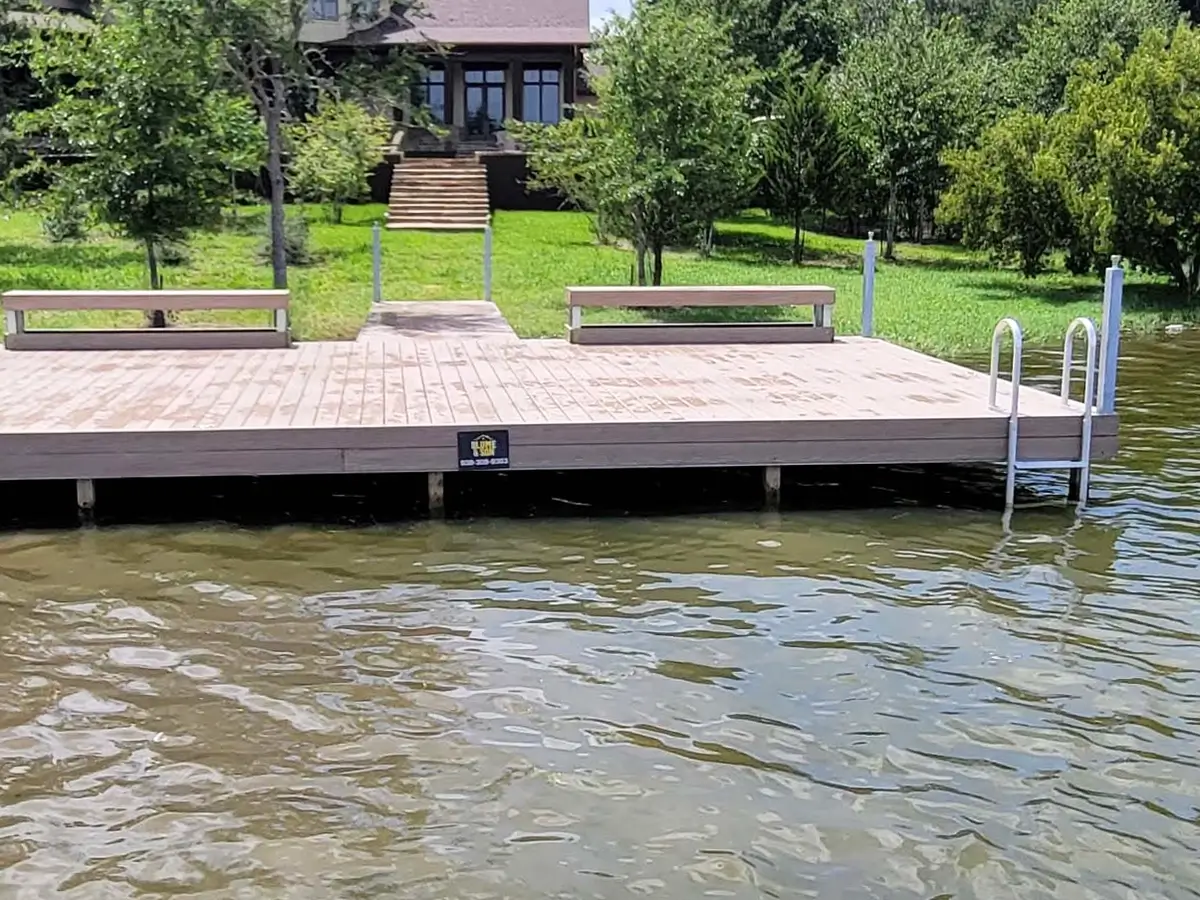 Floating boat dock with a stair case into the water and benches
