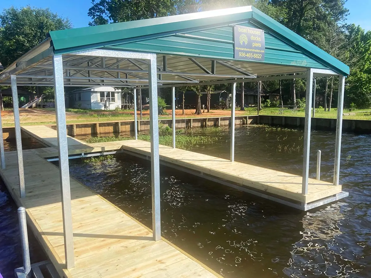 Custom-built boat house and wood dock with metal covered roof