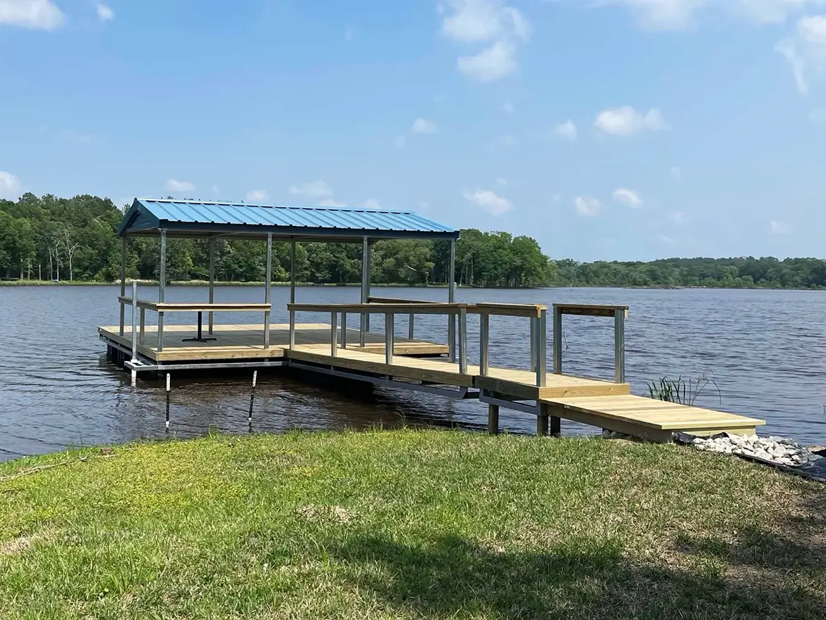 Wood boat dock with railings and a blue metal roof