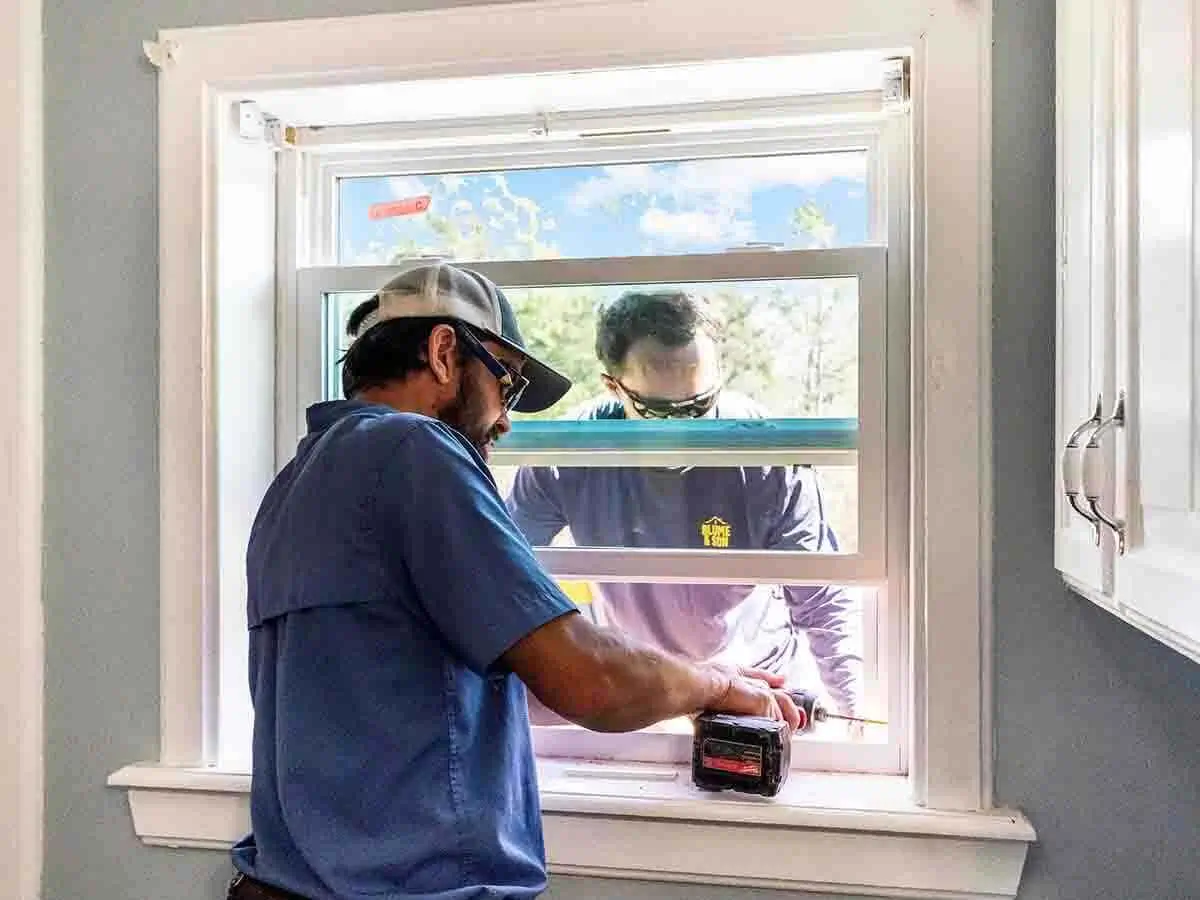 Blume & Son Construction installing new vinyl windows on a house
